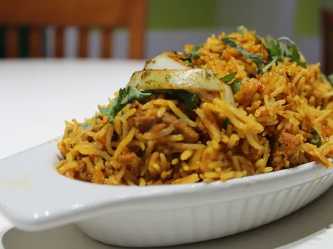 Chicken biryani in a white serving dish